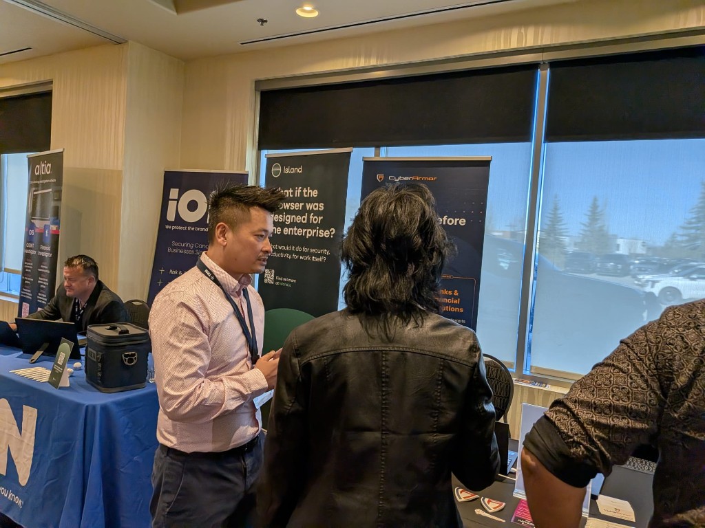 CyberArmor banner and attendees at Cyber Summit Calgary